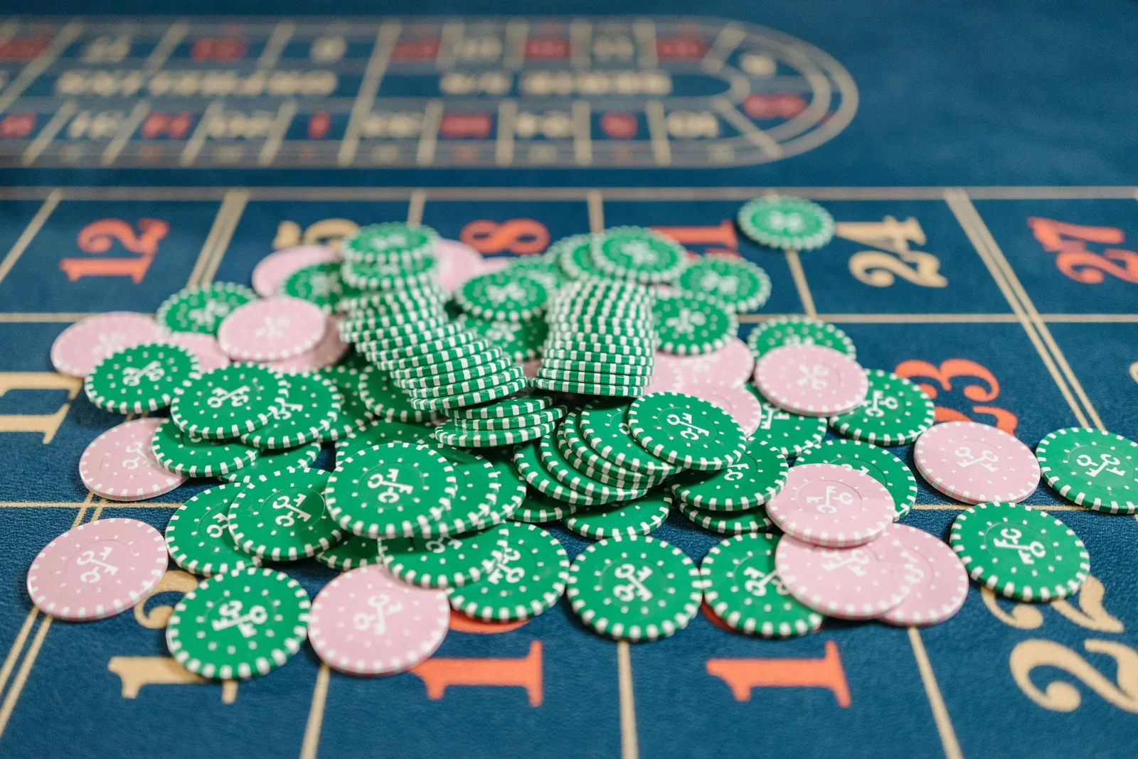 Casino chips piled on a navy Velvetine roulette layout