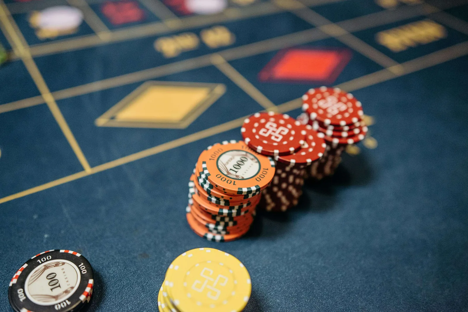 Chips on a navy casino layout printed by Casino Supply UK