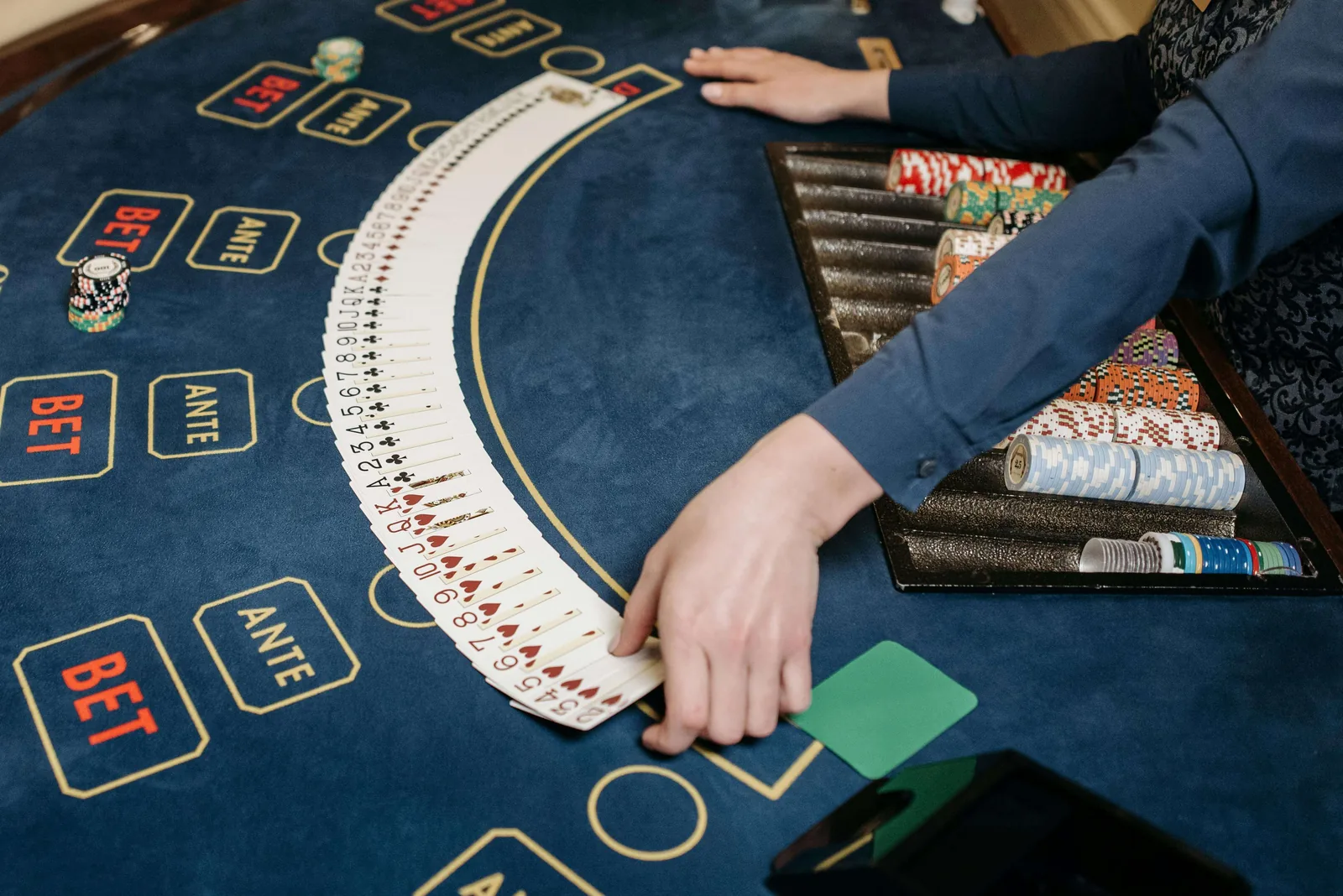 Cards fanned across a navy Velvetine table layout